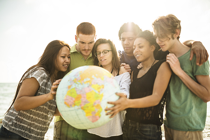 Photo of young people holding a globe