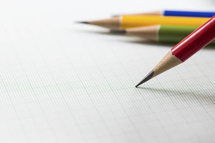 Photo of multicolored pencils on graph paper