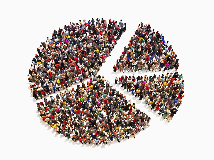 Photo of people standing in a peace sign shaped pie chart