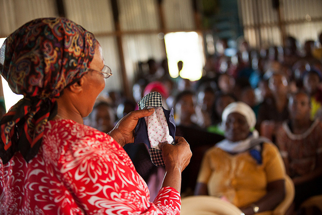 Photo of program volunteer Mrs Wambui Kigoiyo providing reproductive heath and hygiene education.