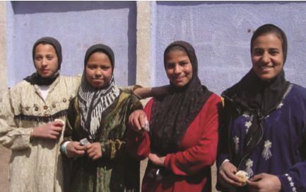 Image of a group of women smiling outside.