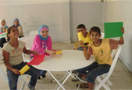 Image of children around a table in classroom