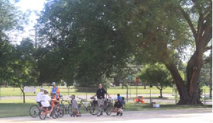 Photo of Newton Bike Rodeo for Latchkey July 25, 2014. Obstacle course with Newton Police Department.