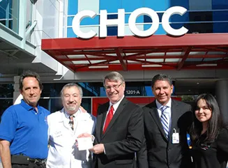 Photo of Children’s Hospital of Orange County receiving the Waste Not OC window seal- Dr. Eric Handler, Dr. Paul Lubinsky, Matthew Gerlach, Waldo Romero, and Bernadet Garcia-Silva.