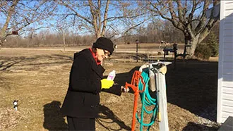 Photo of Linda Briles, Environmental Health Specialist with the Blackford County Health Department, collecting a well sample for BCCC’s well testing project.