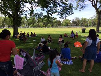 Photo of a summer charla at a local park.