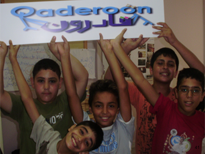 Photo of boys holding a sign saying Qaderoon.