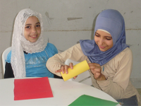 Image of two girls around a table.