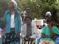 Photo of a community health worker in Komo voicing her opinion during the Community Dialogue Day.